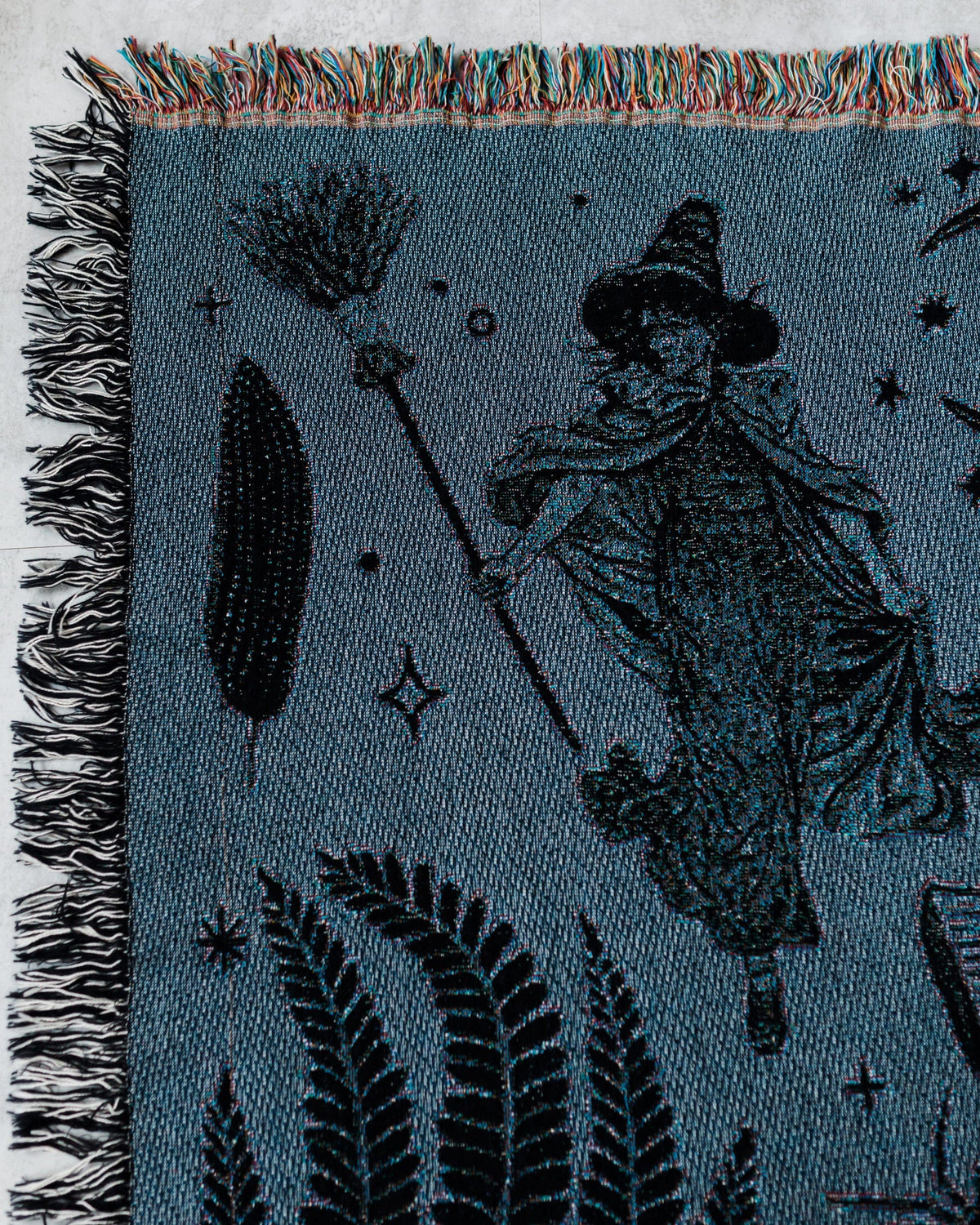 Woven fabric with a witch design on a blue background