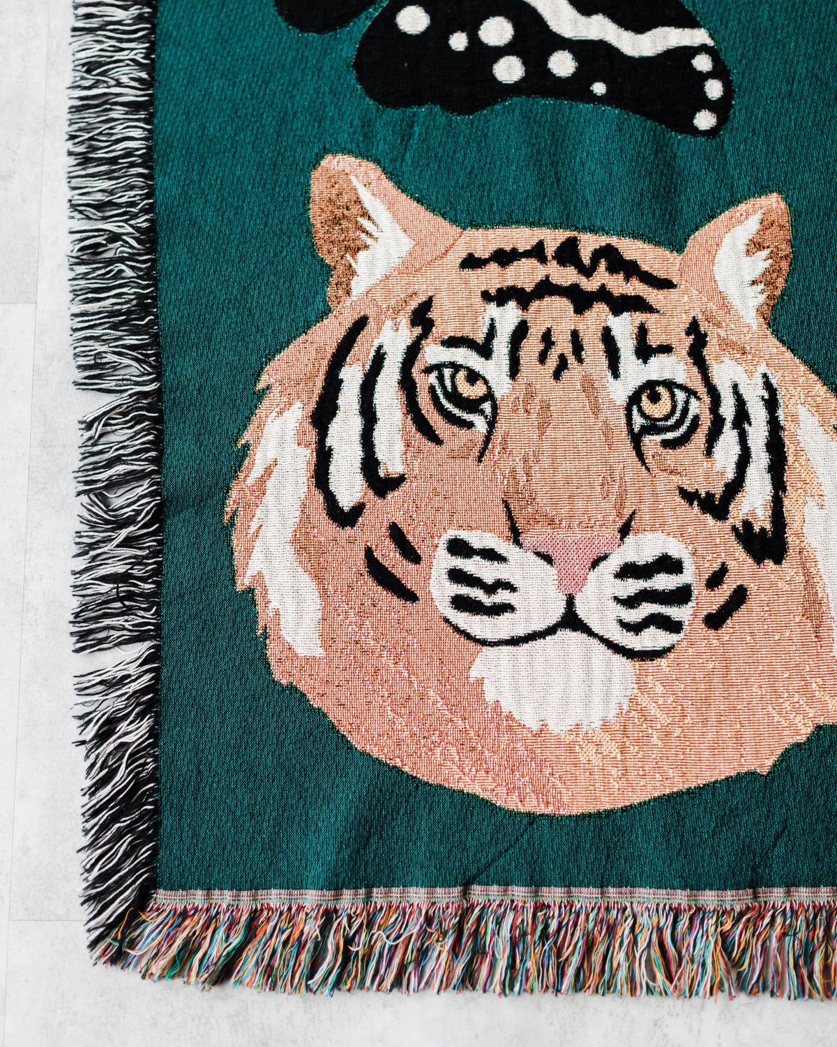 Blanket with a tiger design on a teal background